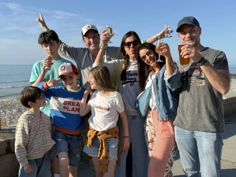 Mélanie, Olivier, their children and friends raising a glass on the seafront at Pourville-sur-Mer